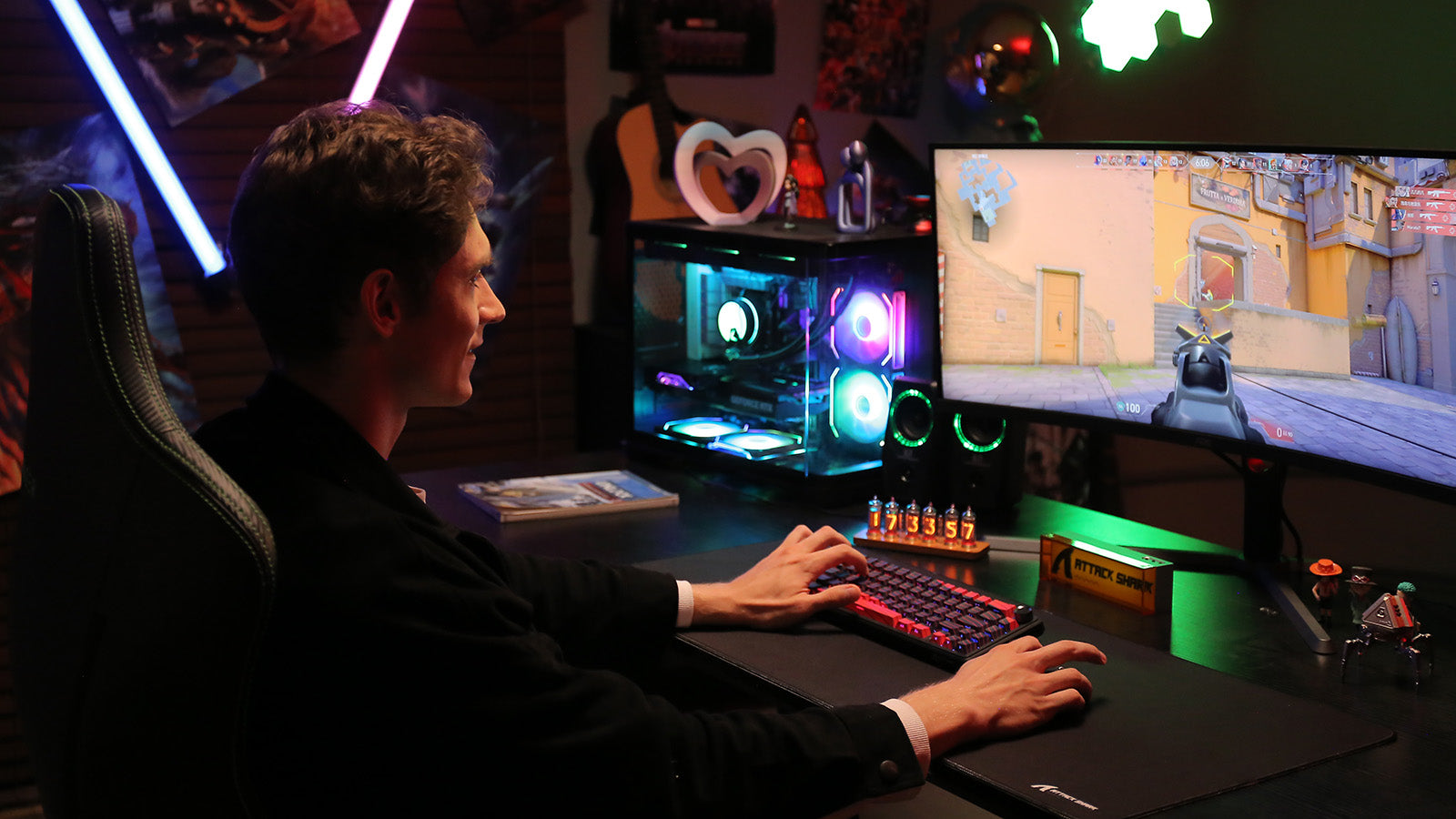 Gamer sitting at a desk demonstrating proper keyboard posture with wrists floating above a 75% mechanical keyboard while playing an FPS game