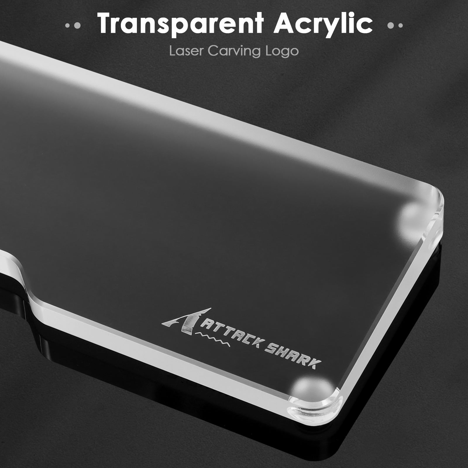 Close-up of transparent acrylic wrist rest with engraved Attack Shark logo.
