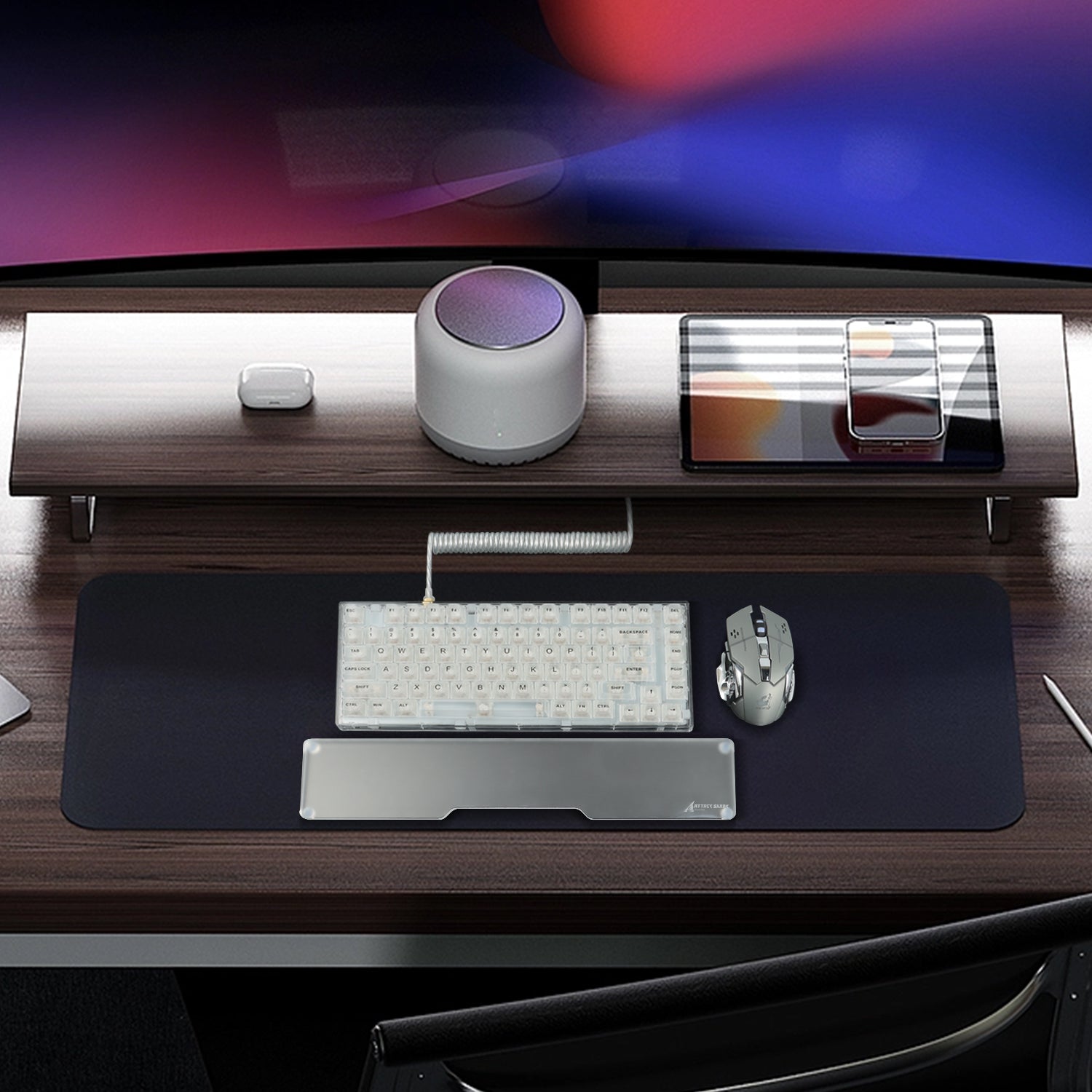 Modern desk with red and white mechanical keyboard, clear acrylic wrist rest, and mouse.