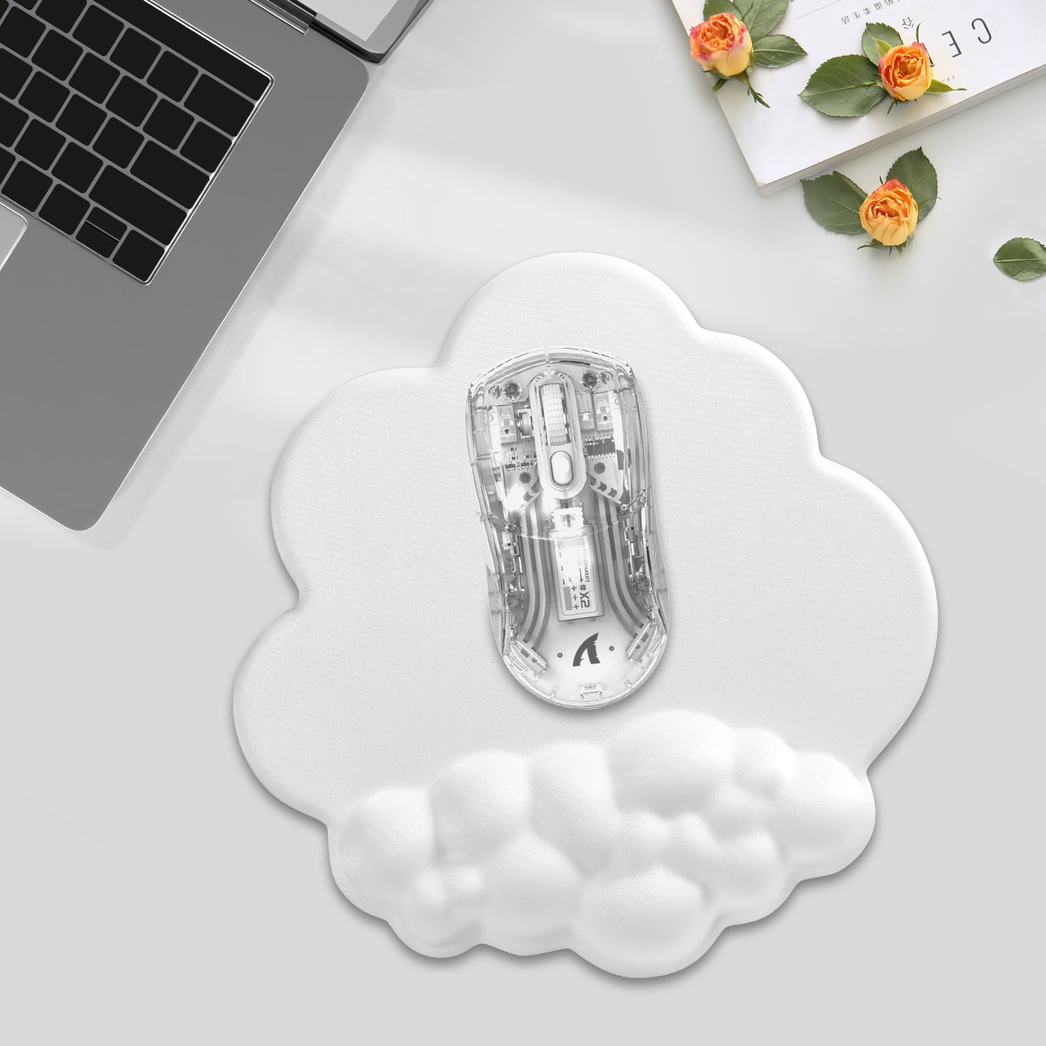 Transparent gaming mouse on cloud-shaped ergonomic mouse pad in modern workspace.